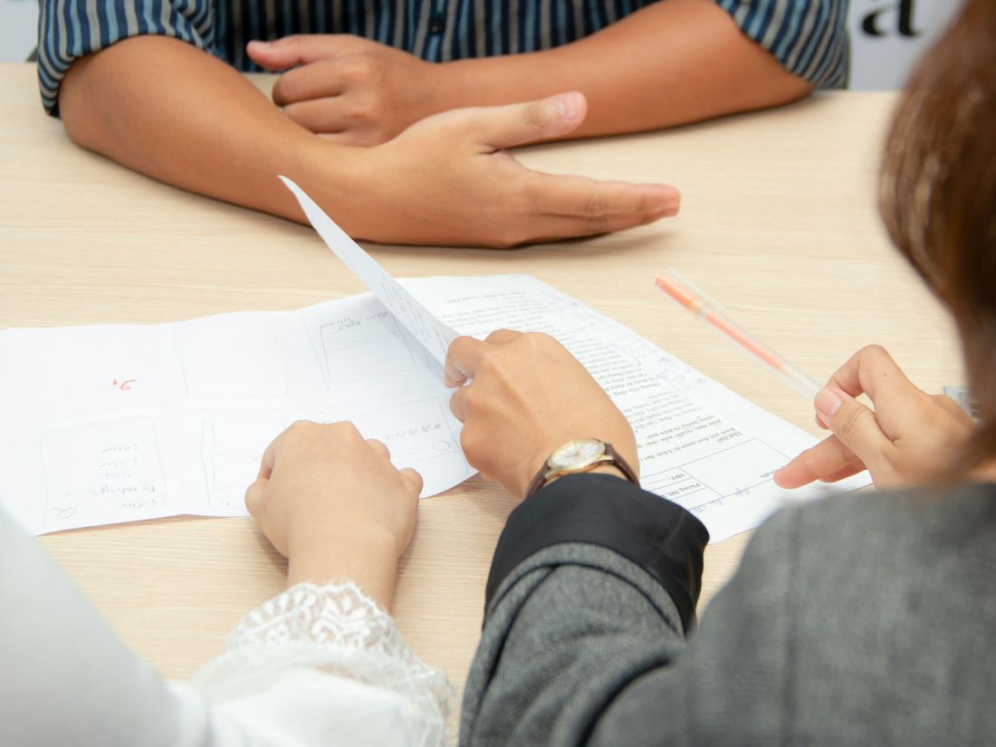 Government program leadership reviewing governance documentation